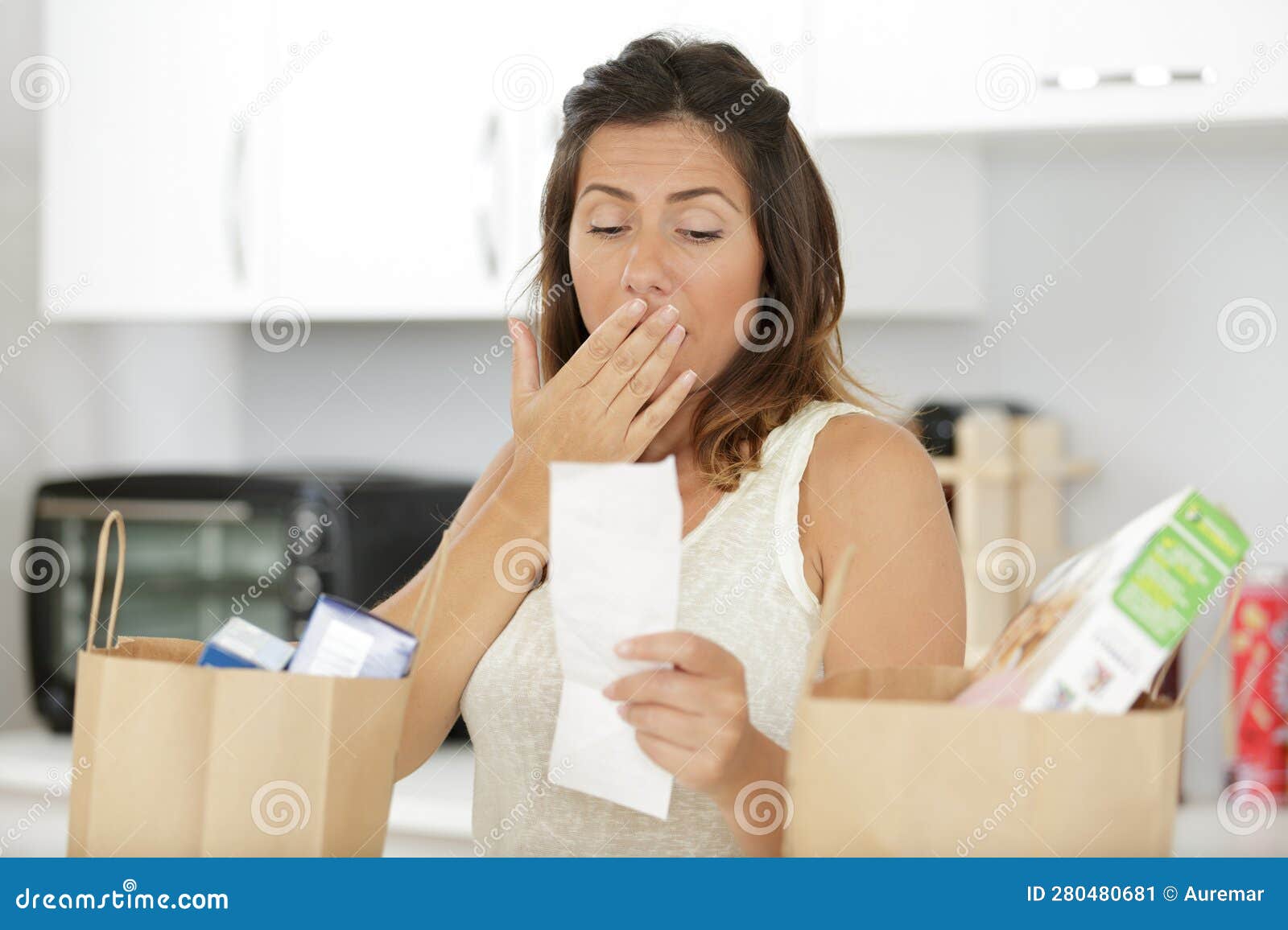 expensive grocery receipt and worried consumer