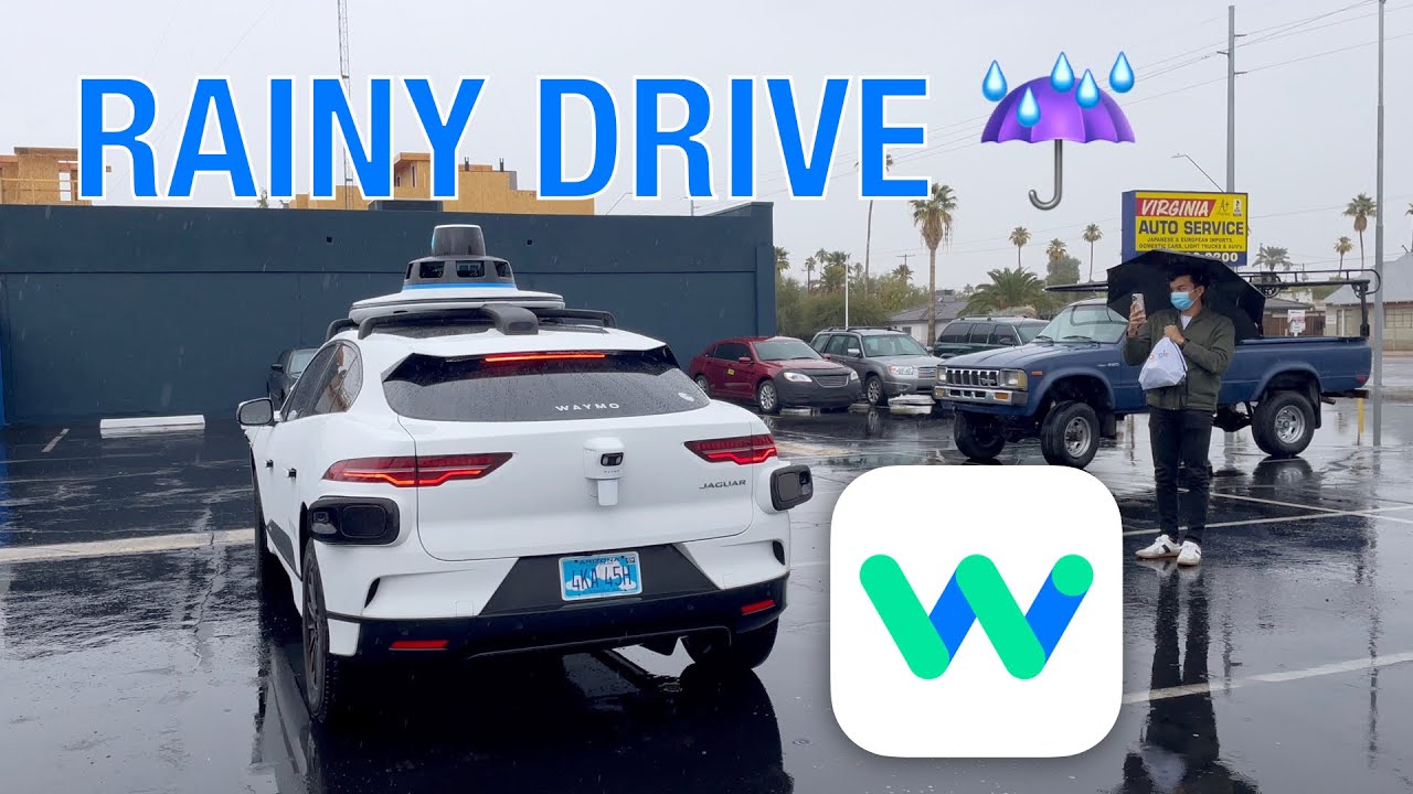Waymo vehicle navigating rainy Portland streets with bridges