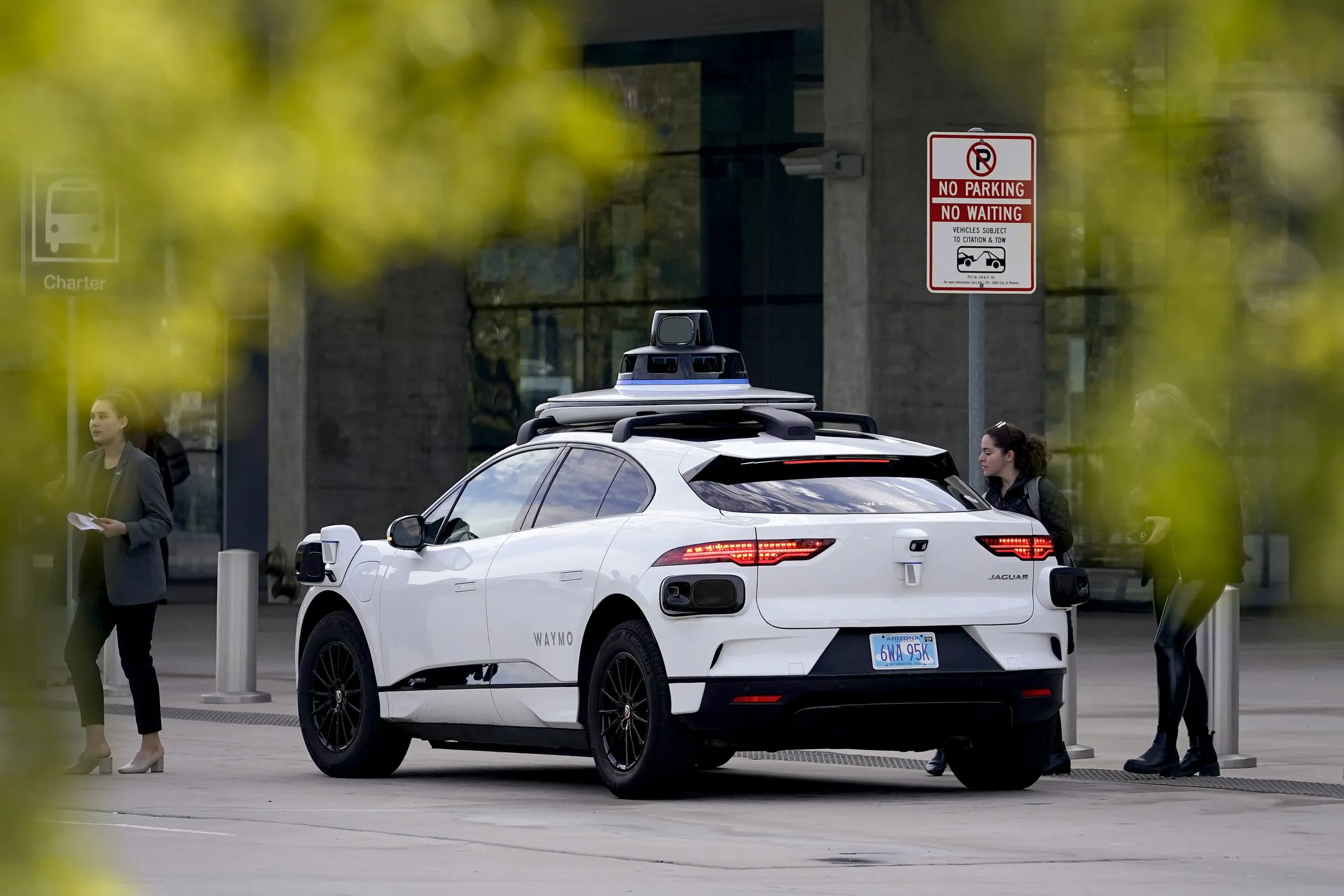 Waymo robotaxi in Portland downtown with light rail